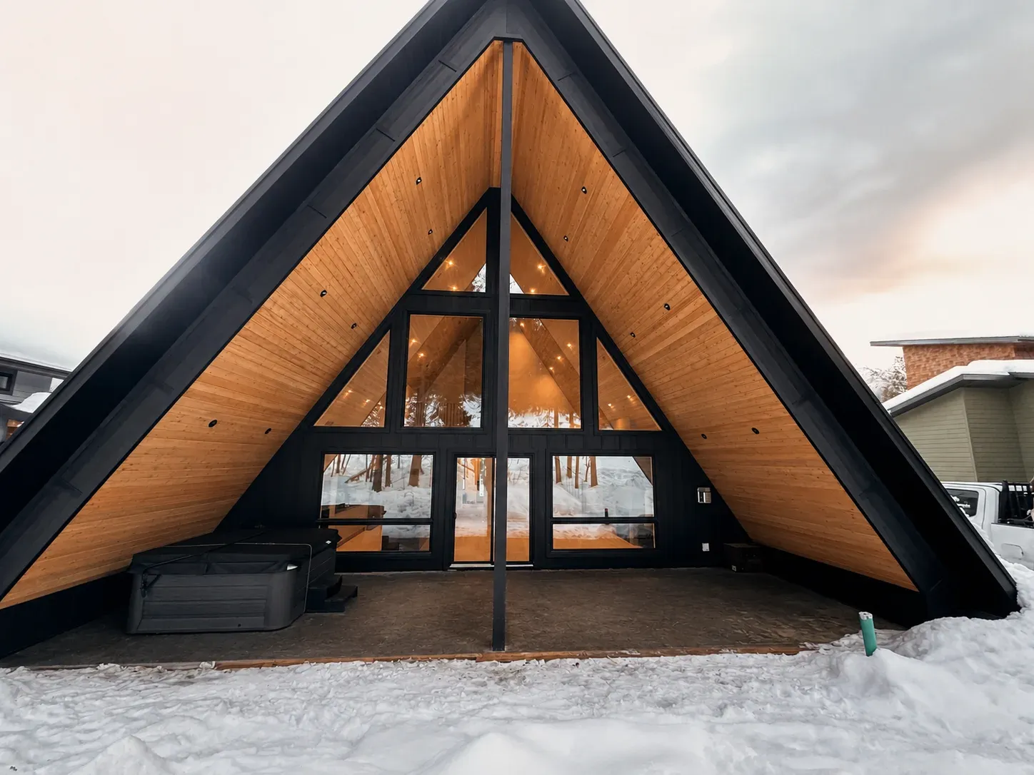 An A-frame ski chalet at dusk in Fernie, BC